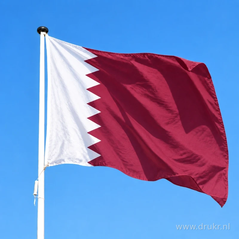 Qatarese vlag wapperend aan een verticale witte mast